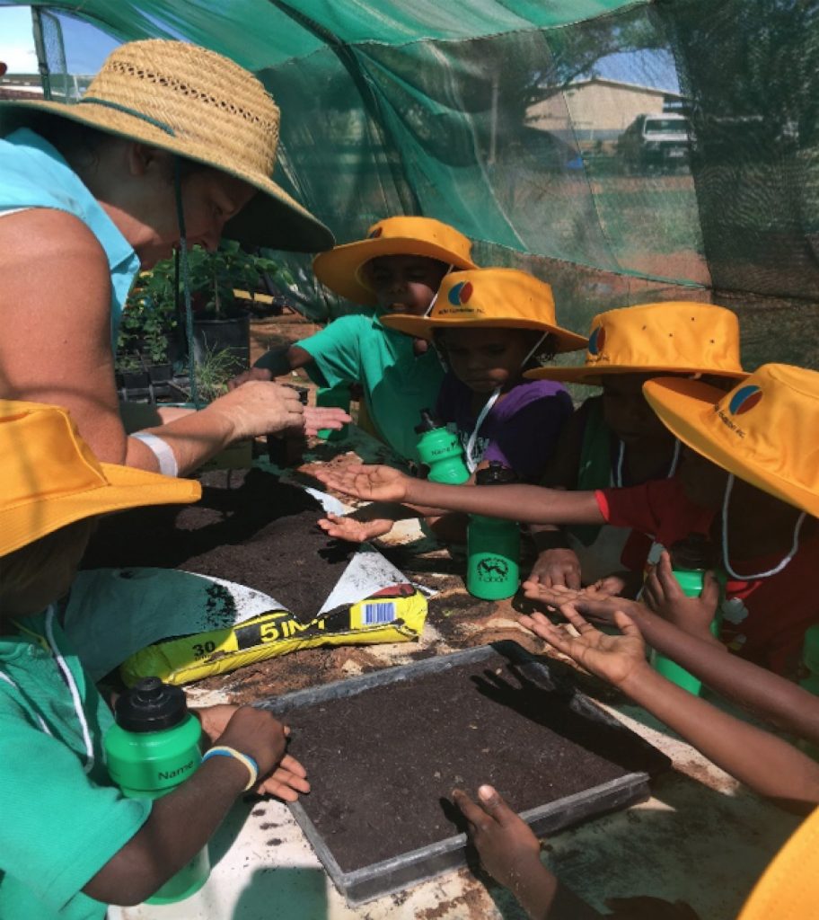 Yakanarra kids planting seeds - image credit EON